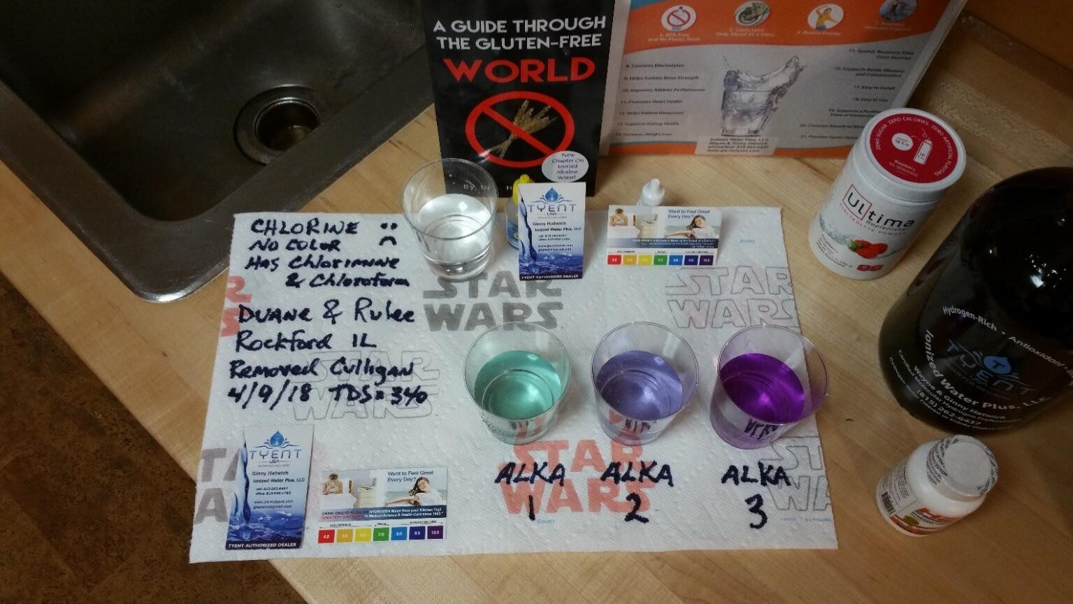 A collection of books, Star Wars figures, and colorful bath bombs on a table.