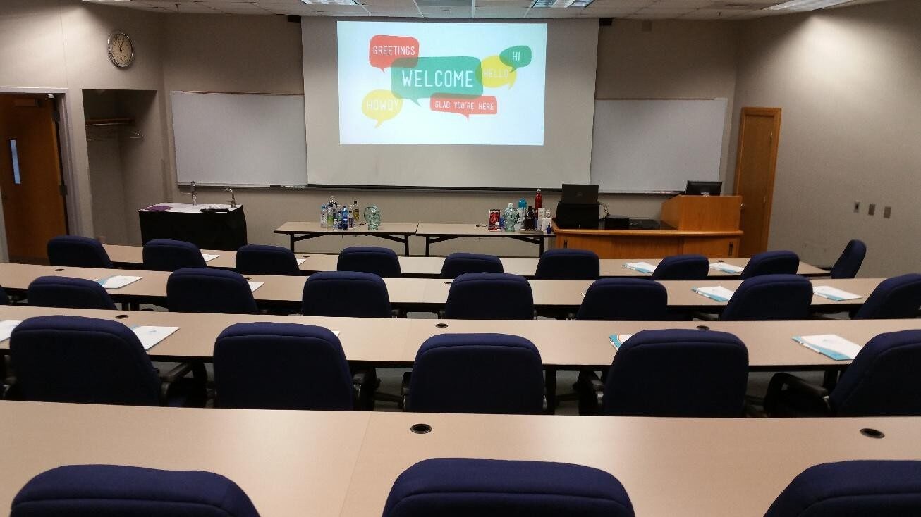 Empty classroom with a presentation slide about skills and tools.