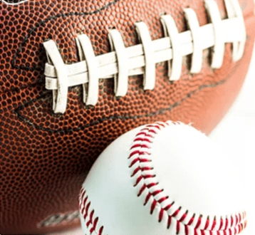 Portrait of a man smiling gently against a teal background.